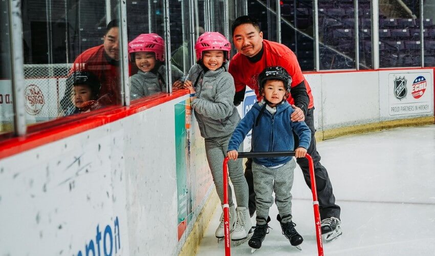 Dad and kids skating at the CAA Centre. 