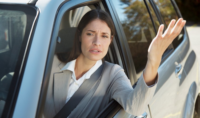 Frustrated female driver in traffic. 