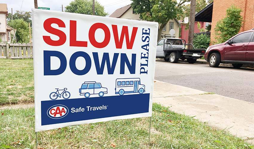 blog-img--slow-down-please-lawn-sign-with-bike-car-bus