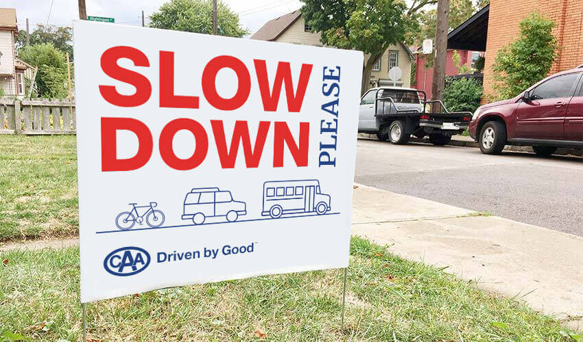 Slow Down Please sign on front lawn