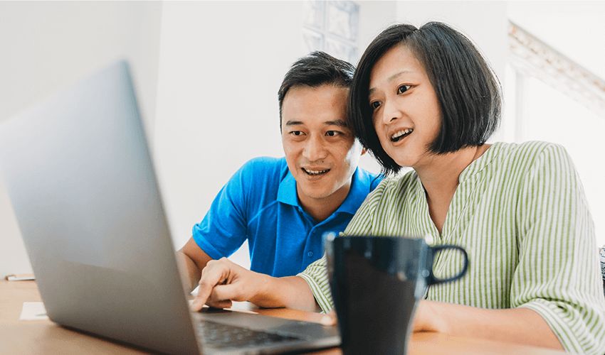 Middle aged couple looking at laptop.