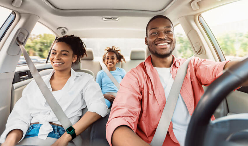 Young parents and daughter in car