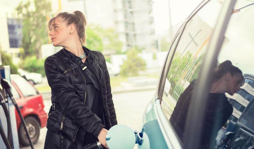 Woman filling car at gas station