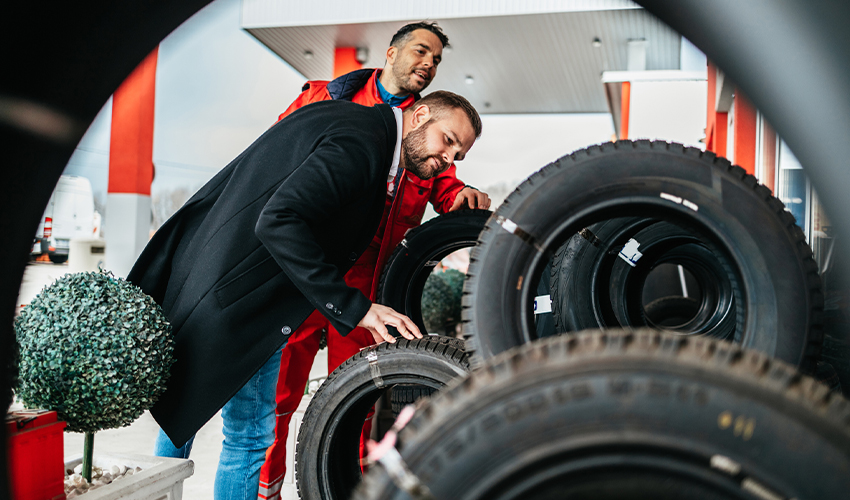 Man looking at winter tires in garage