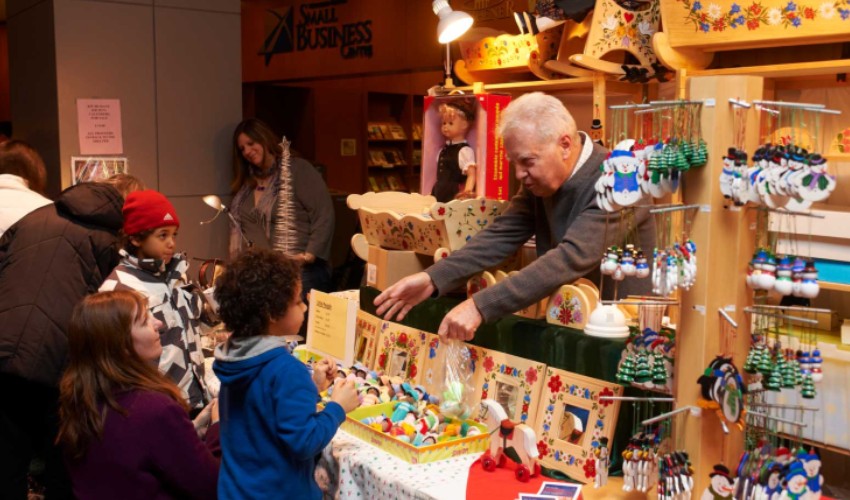 Children and parents shopping at the Christkindl Market at Kitchener City Hall. 