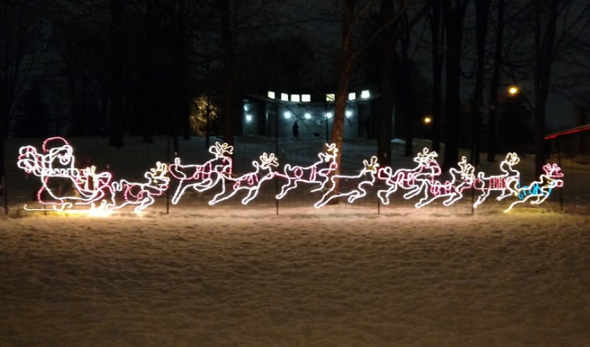 Christmas light display of Santa and his reindeer.