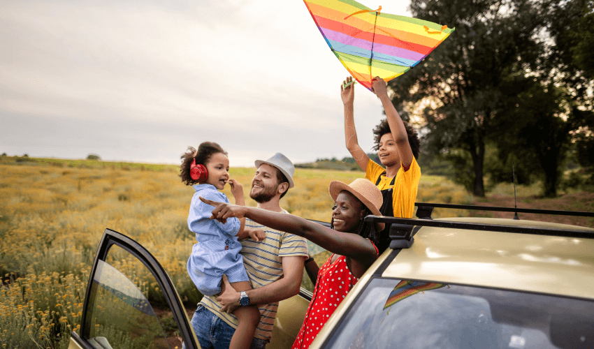 A family with two children getting out of a car.
