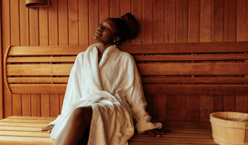Woman relaxing in sauna. 