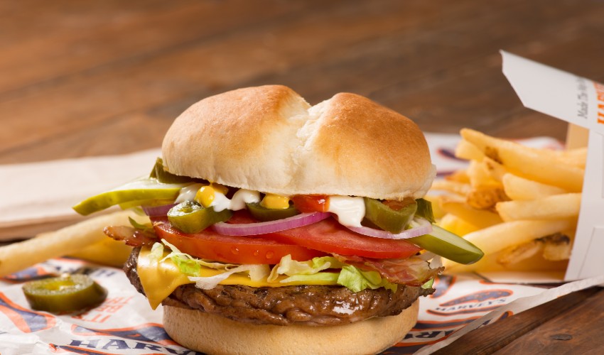 Harveys cheesebuger and fries on table.