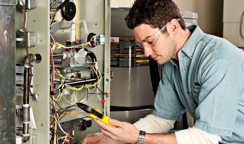 Home inspector checking the furnace.
