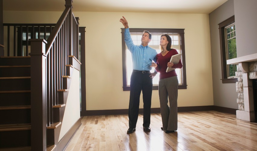 Man and woman inspecting the interior of a home. 