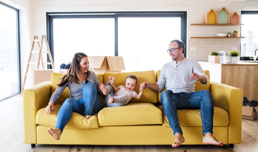 Happy family on a yellow couch.