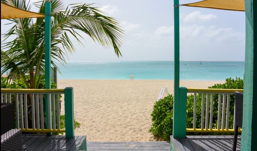 Seaside villa in front of sandy beach and ocean in Turks and Caicos.