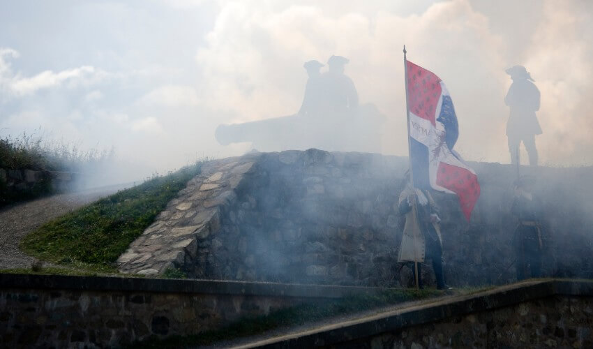 A cannon firing at historic Fortress Louisbourg in Cape Breton Island, Nova Scotia.