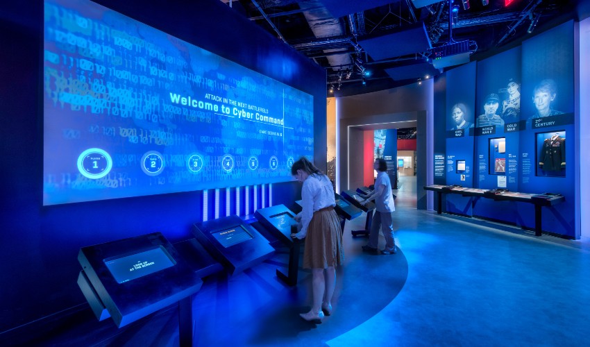 Visitors looking at an exhibit inside the International Spy Museum.