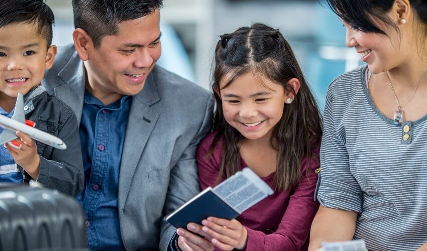 Family watching excited daughter with passport.