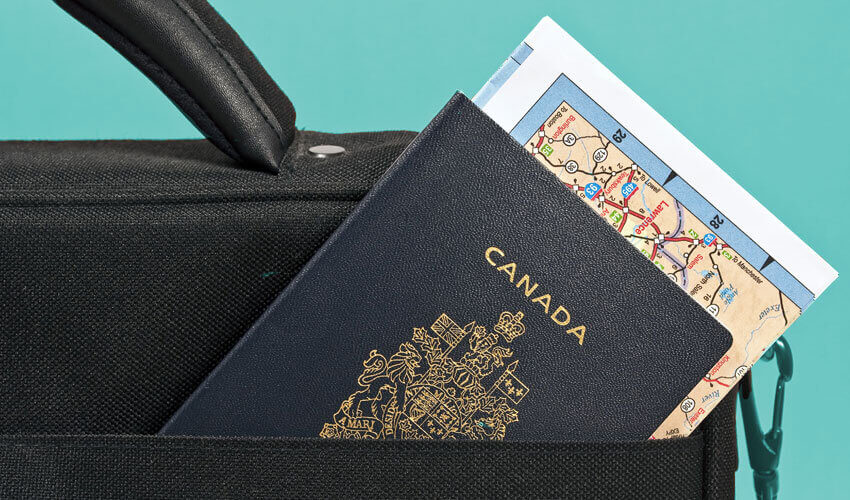 Passport and map sticking out of briefcase.
