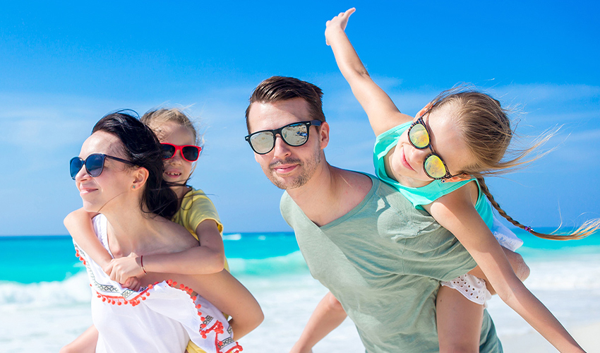 Young family of four on beach