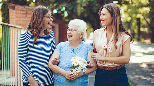 Senior woman walking with two girls