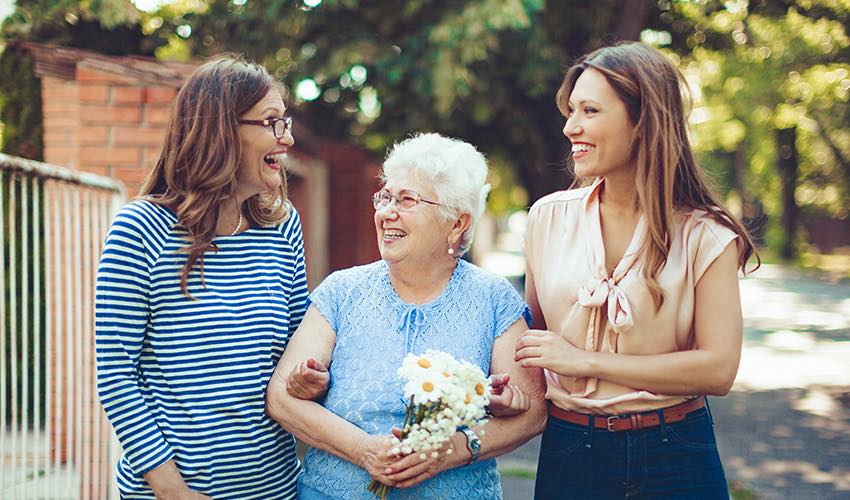 Senior woman walking with two girls