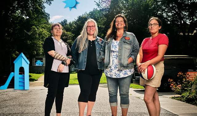 Four women standing in backyard