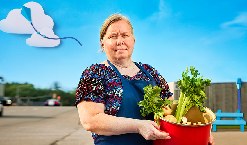 Woman standing holding vegetables