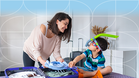 Mother and son packing a suitcase