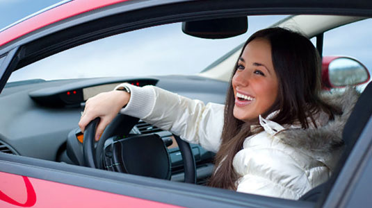 Woman in a car smiling