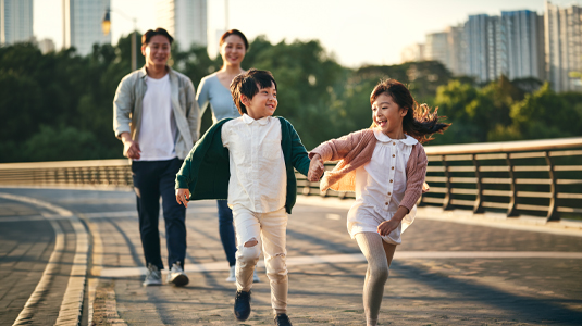 Family of four going for a walk in the park.