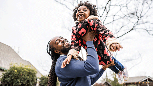 Father lifting his daughter in the air