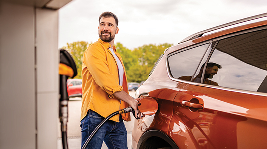 Person filling up his car with gas from the gas station