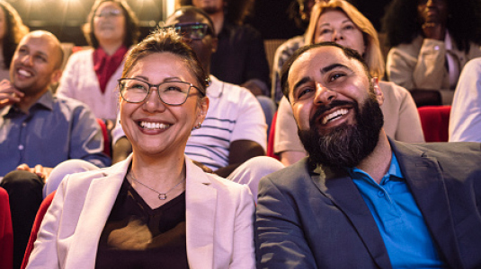 A couple at the theatre enjoying a show