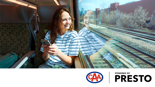 Young woman on a train looking out the window
