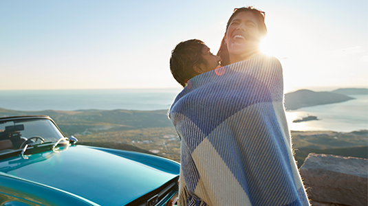 A couple embracing during a sunset.