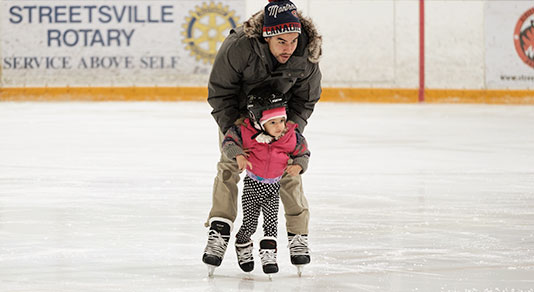 father and daughter ice skating