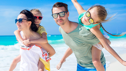 Family of four playing on the beach