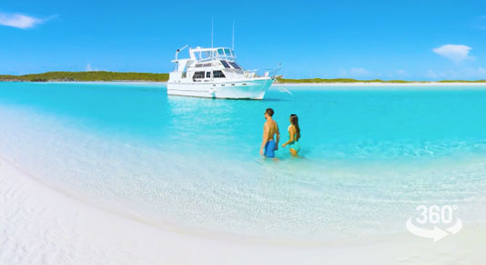 Couple walking on white sandy beach