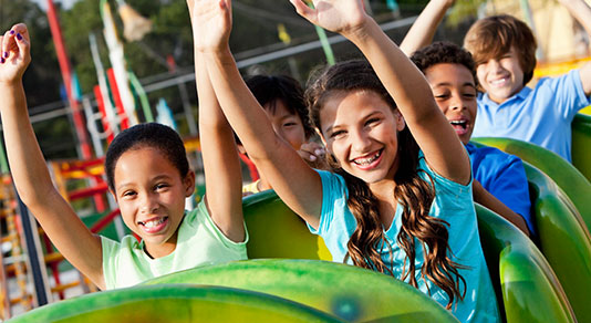 Children riding a roller coaster