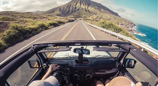 Rear view of a couple driving in a convertible, Lahaina, Maui, Hawaii