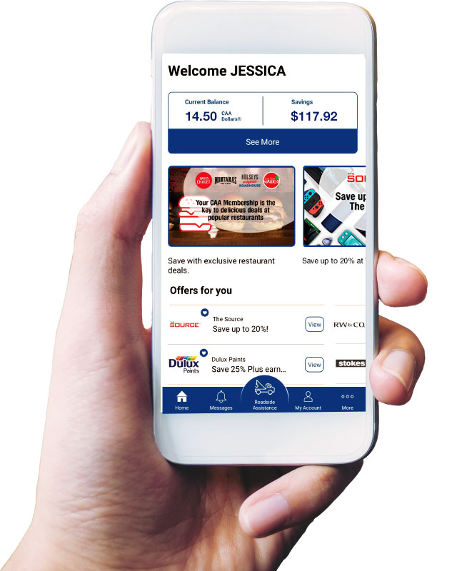 Hand holding a mobile phone that features the home screen of the CAA Mobile App.