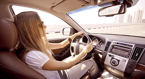 Young girl driving on highway