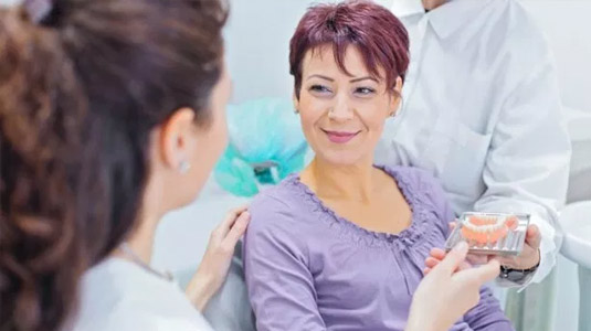 Woman listening to dentist