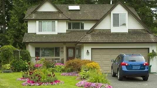 Blue car in front of a house