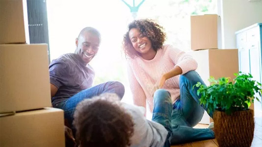 Family laughing surrounded by boxes