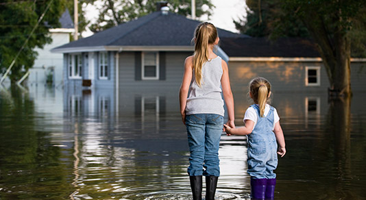 Two girls holding hands watching the floor