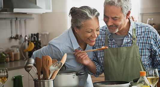 Old couple cooking in kitchen
