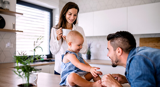 Young couple playing with toddler girl