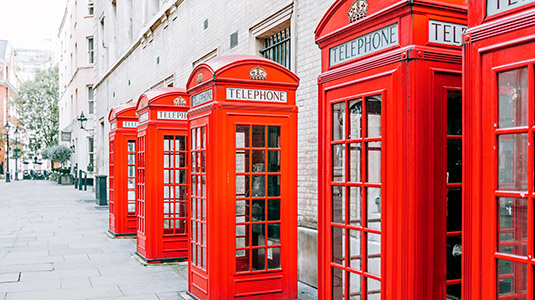 Red telephones lined up in London, England