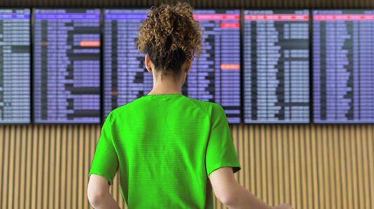 Woman looking at a flight status tracker with cancelled flights