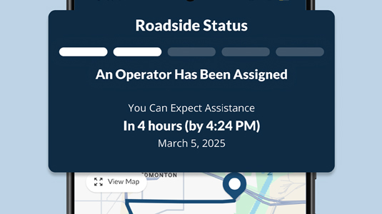 Phone featuring close up of CAA Mobile App Roadside Status screen.